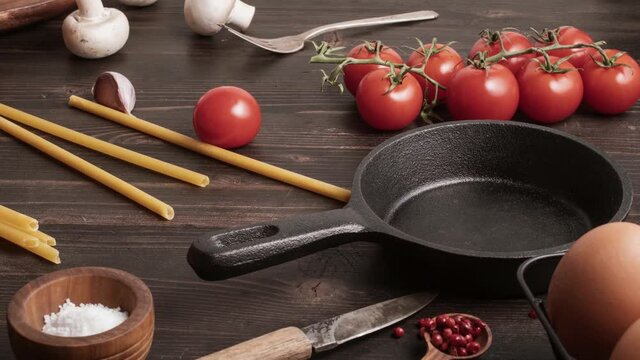 A couple of cherry tomatoes, taking the champignon, move into the frying pan. Stop motion animation