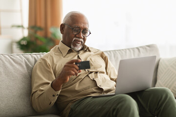 Senior African American Man Shopping Online Using Laptop At Home