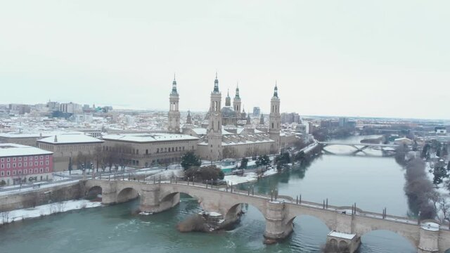 Aerial view in full hd of the city of Zaragoza snowed by the storm Filomena, an unusual image for this city in Spain