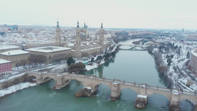 Aerial view in full hd of the city of Zaragoza snowed by the storm Filomena, an unusual image for this city in Spain