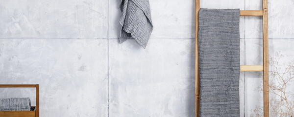 Organic waffle linen towels, bamboo toothbrushes, bathroom zero waste accessories in grey shades in contemporary bathroom interior. Daily body care, spa and wellness zero waste bathroom concept