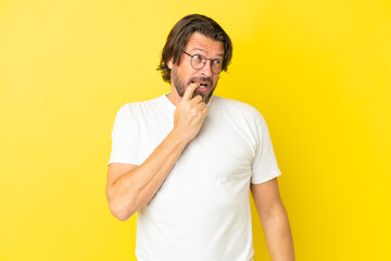 Senior dutch man isolated on yellow background nervous and scared