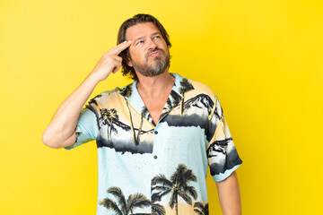 Senior dutch man isolated on yellow background with problems making suicide gesture