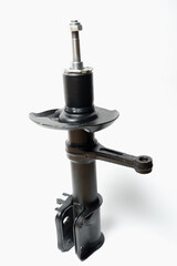 Car spare parts. Car front shock absorber. Contrasting photo on a white background. Front strut hydraulic shock absorber
