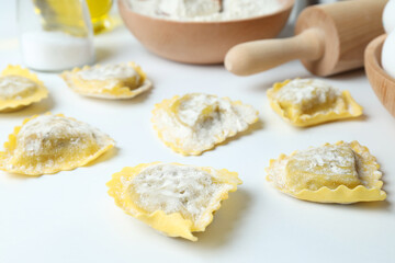 Concept of cooking ravioli on white background