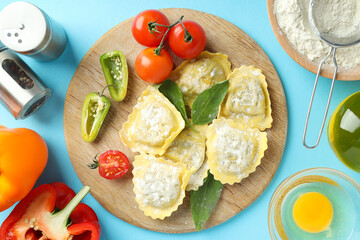 Concept of cooking ravioli on blue background