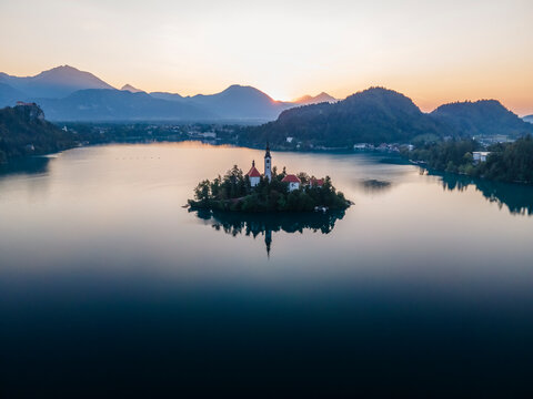 Aerial view of Cerkev Marijinega, a Catholic Church on a small island in the middle of Bled Lake at sunrise, Upper Carniola, Julian Alps, Slovenia.