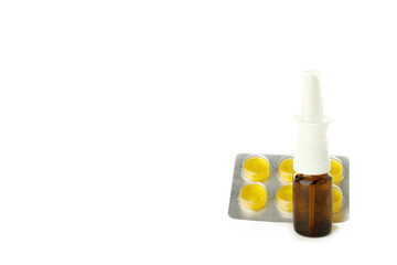 Blank bottle of nasal spray and pills isolated on white background
