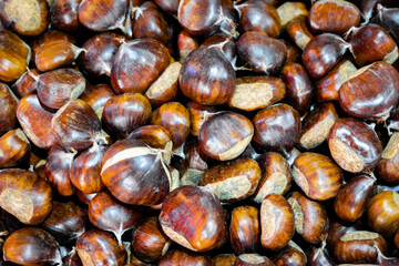 chestnuts close-up, ripe and hacked chesnuts in the market. Organic food photo