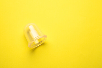 vacuum body massager on a yellow background copy device. an article about massage.