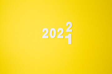 Goodbye, 2021, Happy New Year 2022, inscription. 2021 and 2022 on a yellow background. New 2022 to replace the concept of 2021