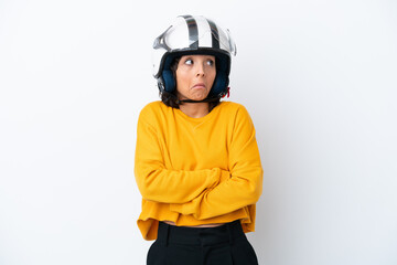 Woman with a motorcycle helmet making doubts gesture while lifting the shoulders