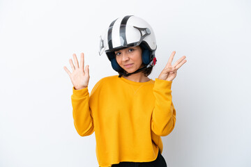 Woman with a motorcycle helmet counting eight with fingers