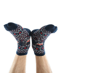 Male legs in Christmas socks isolated on white background