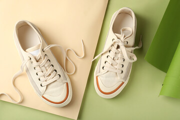 Pair of beige sneakers on two tone background
