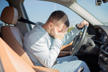 Stressed man feeling headache in car, keeping hand to head and feeling anxiety. Driver falling...