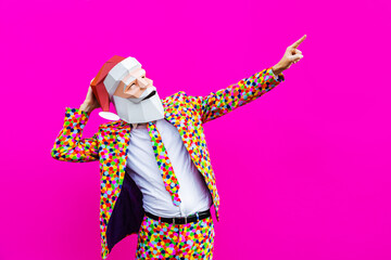 Man with funny low poly Santa Claus mask on colored background