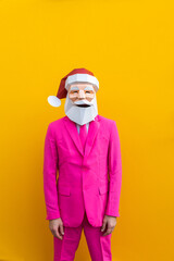 Man with funny low poly Santa Claus mask on colored background