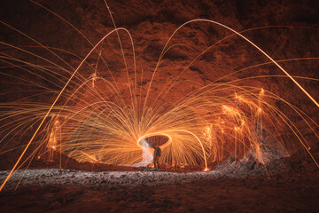 Man wielding rounded burning fire spark