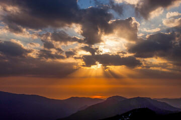 Russia, Krasnodar Territory. Sochi. Rosa Khutor Mountain Resort. Sunset over the peaks of the Aibga...