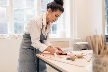 A woman's hobby is working with clay. The sculptor makes handmade tableware. The master of ceramics...