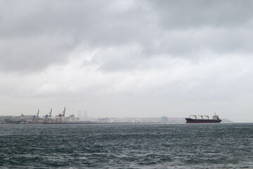 cargo ship in the Bosporus strait with Istanbul city view on background