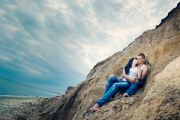 Fototapeta premium guy and a girl in jeans and white t-shirts on the beach