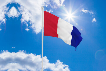 Flag of france waving in the wind, sky and sun background. France Flag.