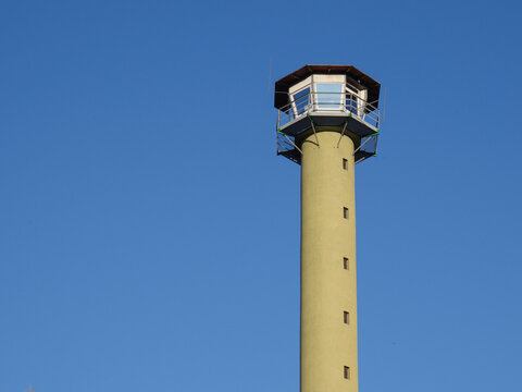 The Czubatka lighthouse in the Błędowska Desert in Poland against the sky.