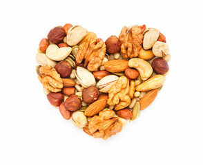 Heart shaped nuts and seeds isolated on white background close-up, flat lay, top view