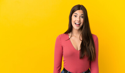 Teenager Brazilian girl over isolated yellow background with surprise facial expression