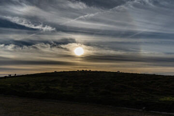 Day and Night with a crescent moon at the end of summer in the mountains of Asturias, with horses and a sunset of color!