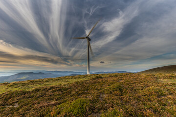 Day and Night with a crescent moon at the end of summer in the mountains of Asturias, with horses...
