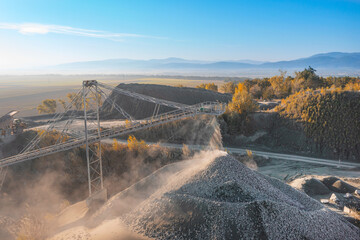 Stone crushing machine. Falling stones in the quarry