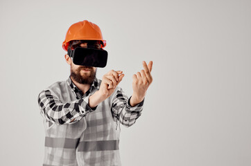 male worker in an orange helmet technology Professional light background