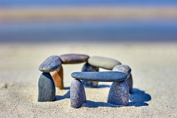 Fototapeta na wymiar Stones are stacked on the beach. Little stonehenge