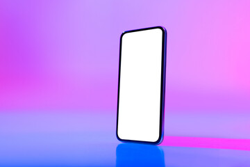 Contemporary cellphone with blank white screen in neon light, mockup for cool mobile app or website