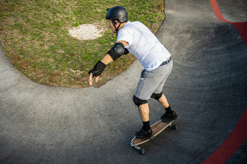 Skateboarder practice on a pump track park © homydesign