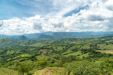 Naklejka na ściany i meble Panoramic landscape in Tamesis with blue sky and mountain on the horizon. Colombia. 