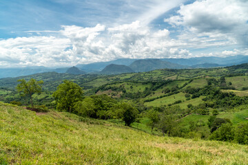 Fototapeta na wymiar Panoramic landscape in Tamesis with blue sky and mountain on the horizon. Colombia. 