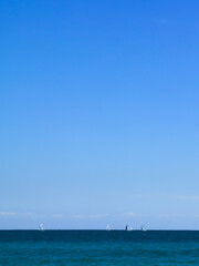 Summer vertical background. Boats, sea, sky and copy space for text