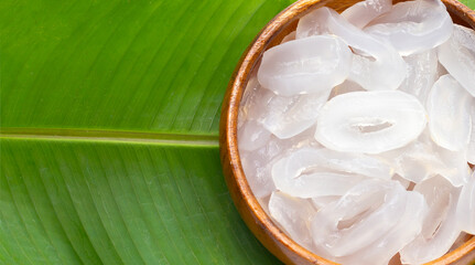 Toddy palm slices in wooden bowl on banana leaf
