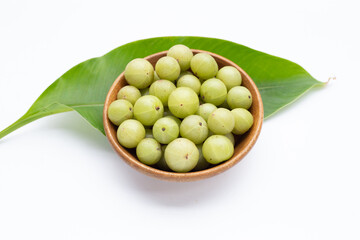 Fresh emblica in wooden bowl on white background.