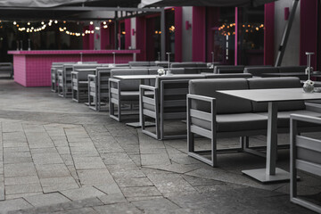 empty tables and chairs on the restaurant terrace during covid, restaurant quarantine restrictions