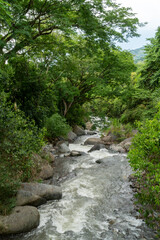 Fototapeta na wymiar Natural landscape with Cartama river and mountains. Tamesis, Antioquia, Colombia.