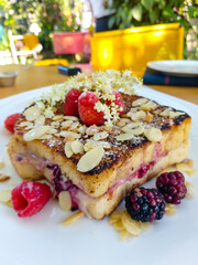 special bread dessert decorated with natural flowers, hazelnuts and red berries