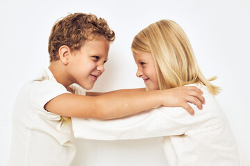 Two children boy and girl smile posing casual wear light background