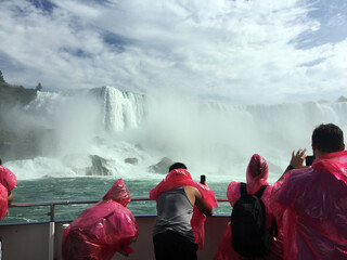 Visitors to the Canadian side of Niagara Falls wear masks while enjoying a river boat ride.