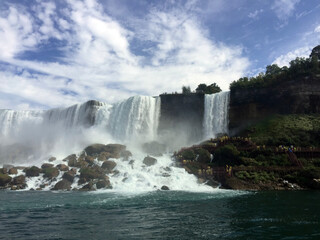 Fototapeta premium The American side of Niagara Falls, seen from a tour boat on the Niagara River. Bridal Veil Falls is seen to the right.