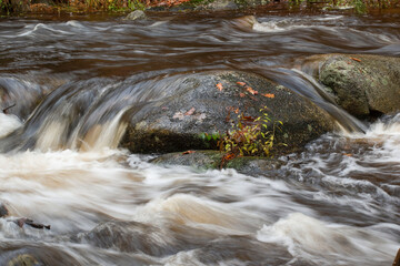 water cascading over rocks after a heavy rain at willard brook